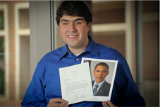 photo of Sina with a letter from the President