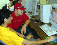 Brian Statler works with a camp counselor on his computer game. 