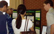 Photo of the John Deere senior design team explaining their project to Posters & Pies visitors.