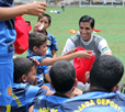Photo of Romulo Manzano and young soccer players in Venezuela.